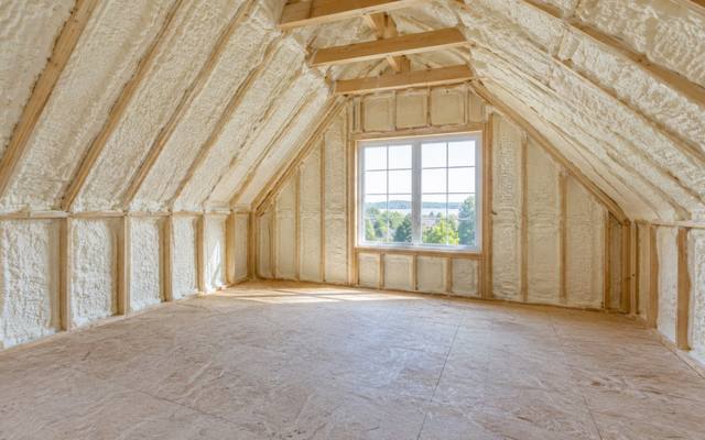 Sloped ceiling and knee walls of a room over a garage sprayed with foam in Doon